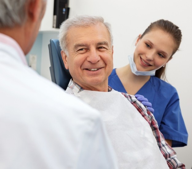 Senior man smiling at his dentist