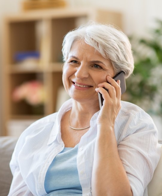 Senior woman on phone with Arlington Heights dental office