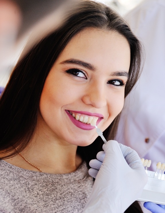 Young woman being fitted for veneers by cosmetic dentist