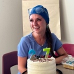Dental team member with cake with candles of the number 97
