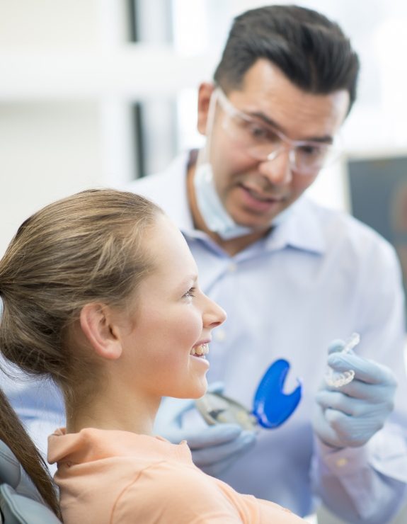 Dentist fitting a patient with Invisalign