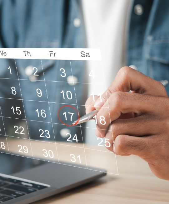 Person circling date on calendar of dental appointment in Arlington Heights