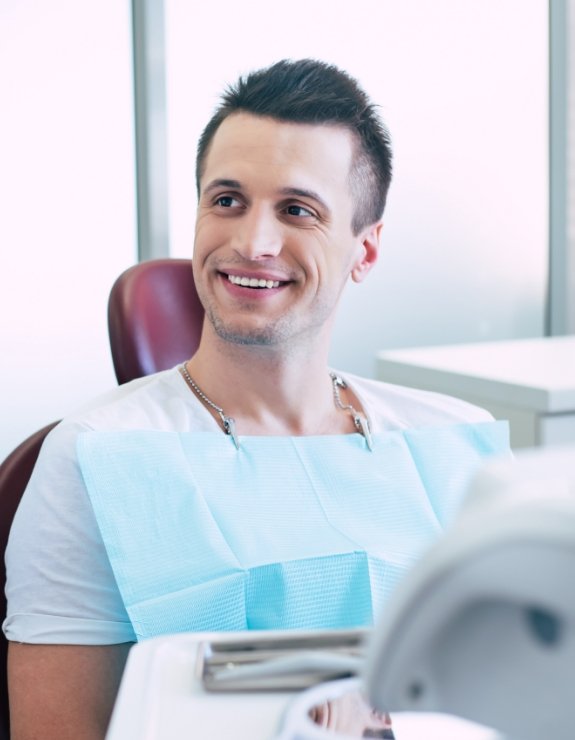 Smiling man sitting in dental chair