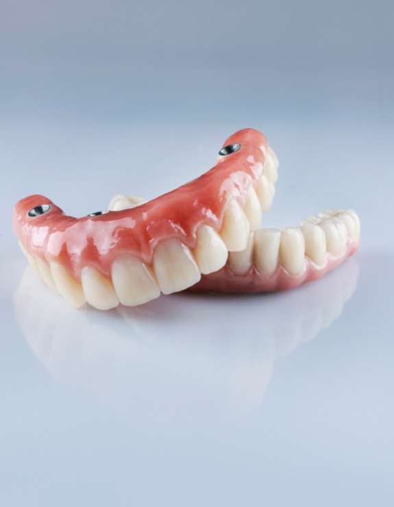 Two dentures resting on flat surface