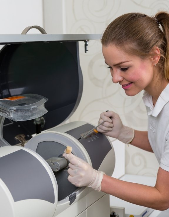 Dental team member using CEREC machine