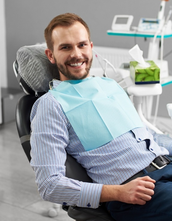 Smiling man sitting in dental chair