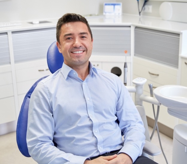 Smiling man sitting in dental chair