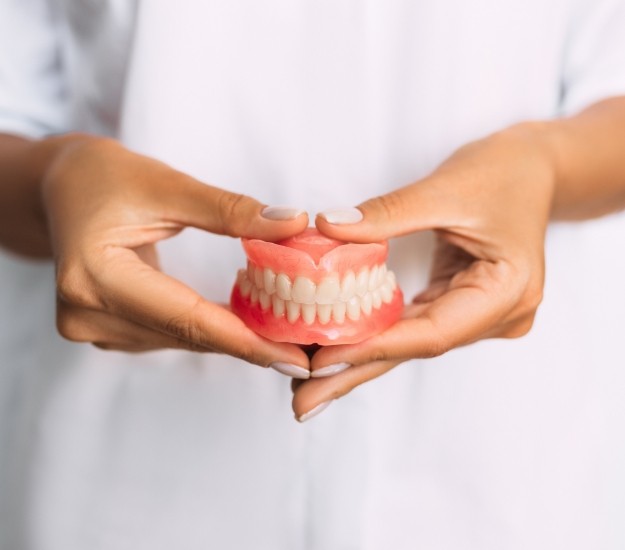 Dentist holding a set of full dentures