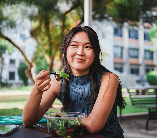 Patient in Arlington Heights eating healthy with dental implants