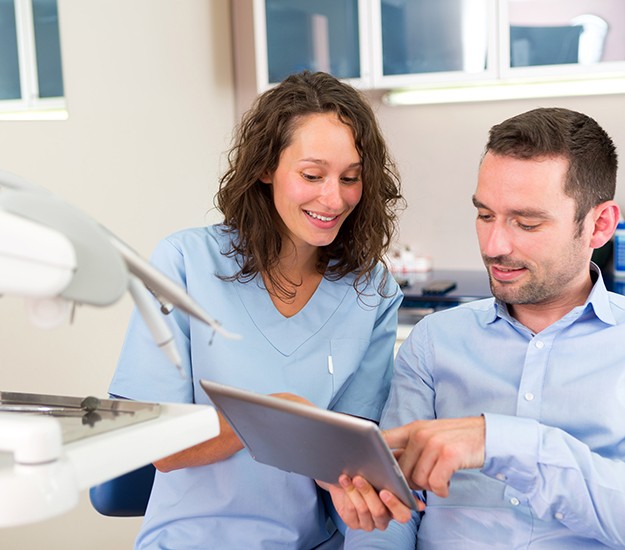 Patient in Arlington Heights talking to dentist about dental implants