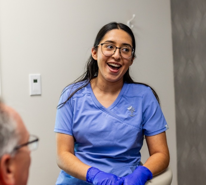 Dental team member talking to a patient