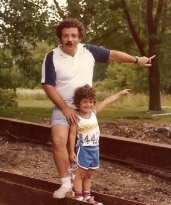 Photograph from several decades ago of a father and son in forest pointing to trees