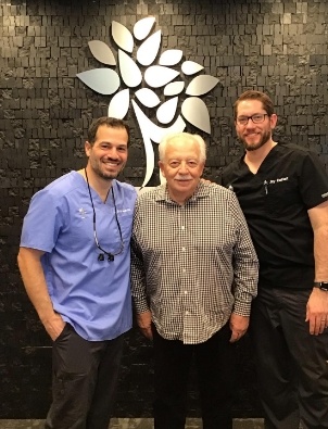 Three Arlington Heights dentists smiling in dental office