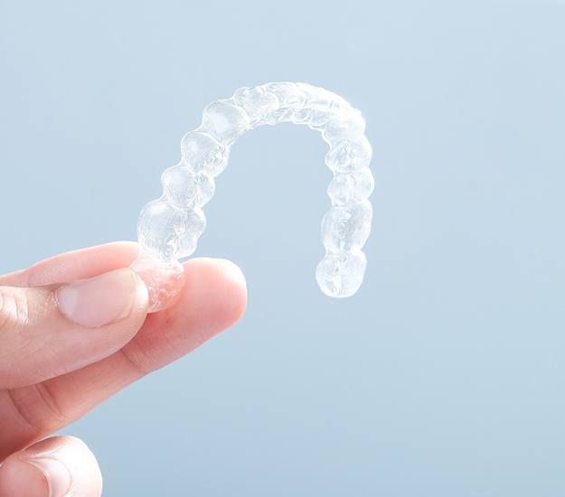 Patient holding clear aligner