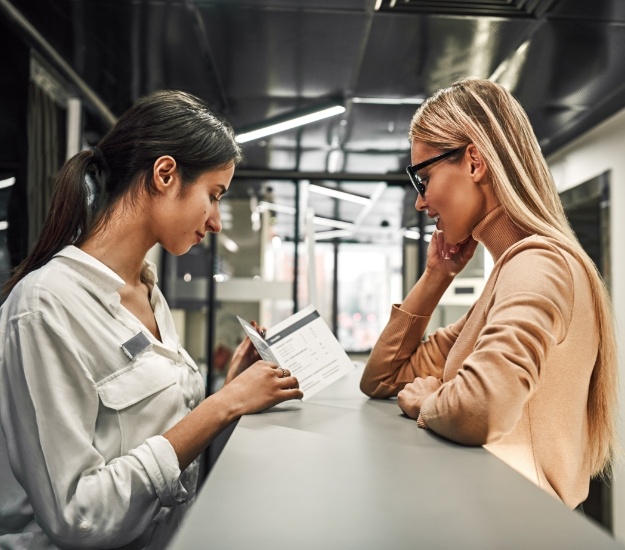 Woman talking to receptionist