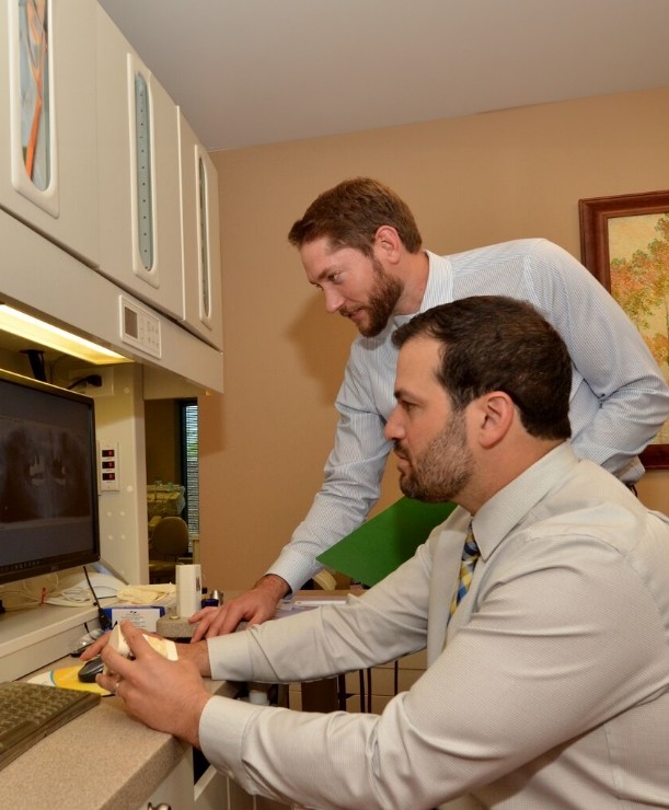 Arlington Heights Illinois dentist Doctor Jay DeHart looking at computer in dental office