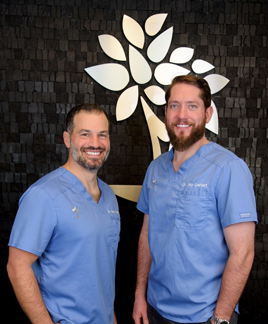 Doctor Ernie Costello and Doctor Jay DeHart smiling in Arlington Heights dental office