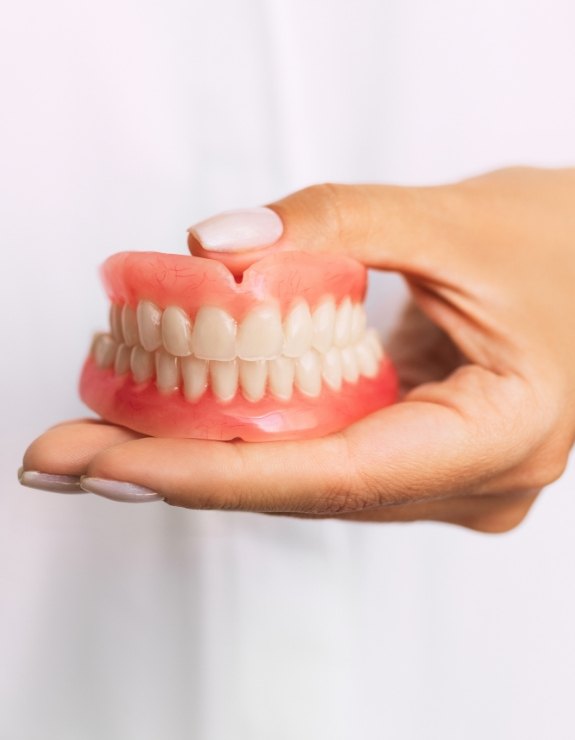 Dentist holding a set of full dentures