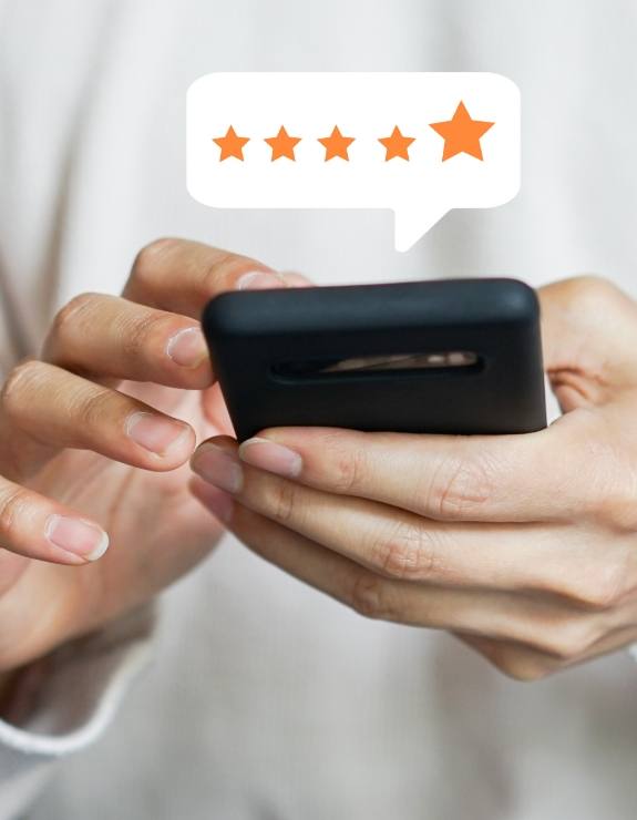 Person leaving a five star review on their phone