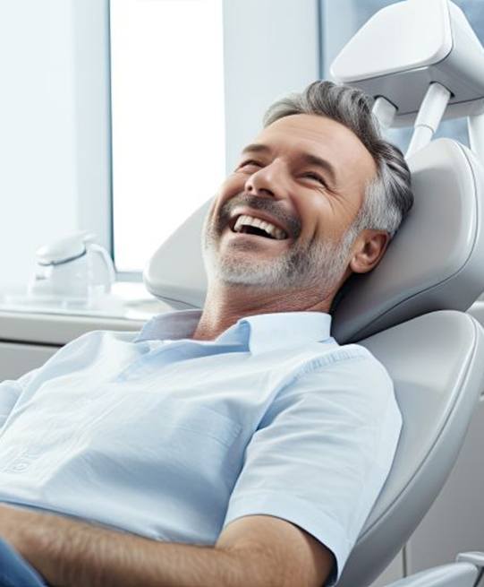 Male dental patient making thumbs up gesture