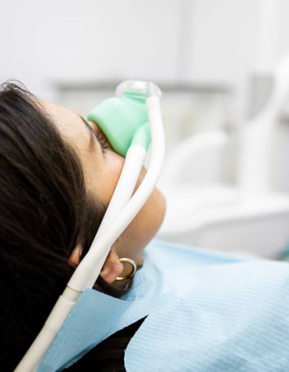 Woman preparing to swallow a pill