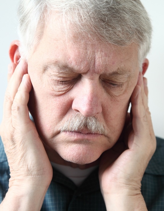 Man holding his temples in pain