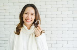 woman holding aligner