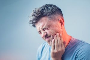 man with toothache who needs emergency dentist