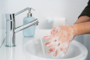 Woman washing hands with soap