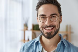 Man with attractive smile after cosmetic dental treatments.