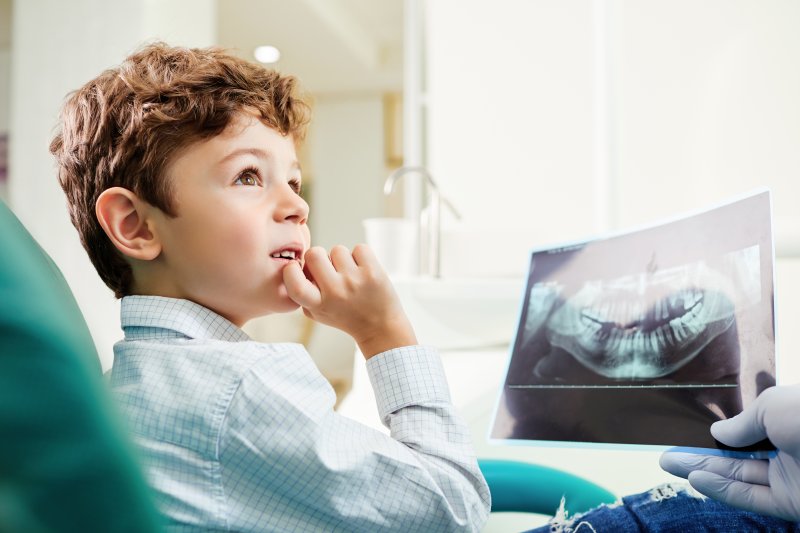 dentist showing child their dental x-ray