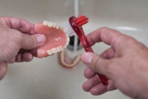 denture cleaning with brush