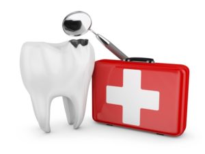 a tooth in front of a dental emergency kit